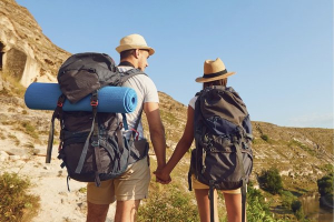 Couple hiking with backpacks, enjoying visual freedom after laser eye surgery