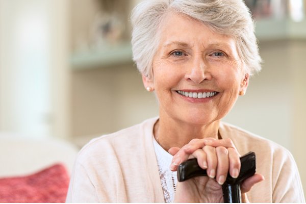Smiling senior woman with clear, bright eyes and confident expression showing successful results after cataract surgery