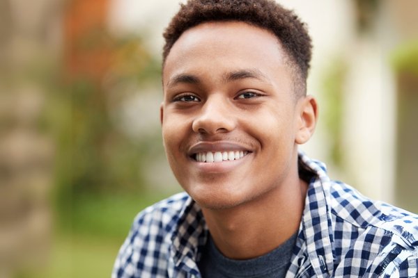 Young man smiling outdoors, representing successful keratoconus management with cross-linking